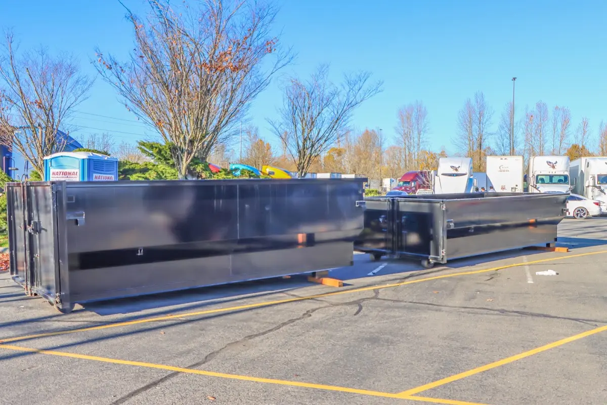 Professional dumpster rental service with roll-off container on residential driveway in Linwood